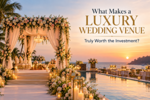 Luxurious Sunset Seaside Wedding Venue - XINANE Sunset luxury wedding venue with a flower-adorned arch, chandeliers, and candlelit aisle along a poolside walkway.